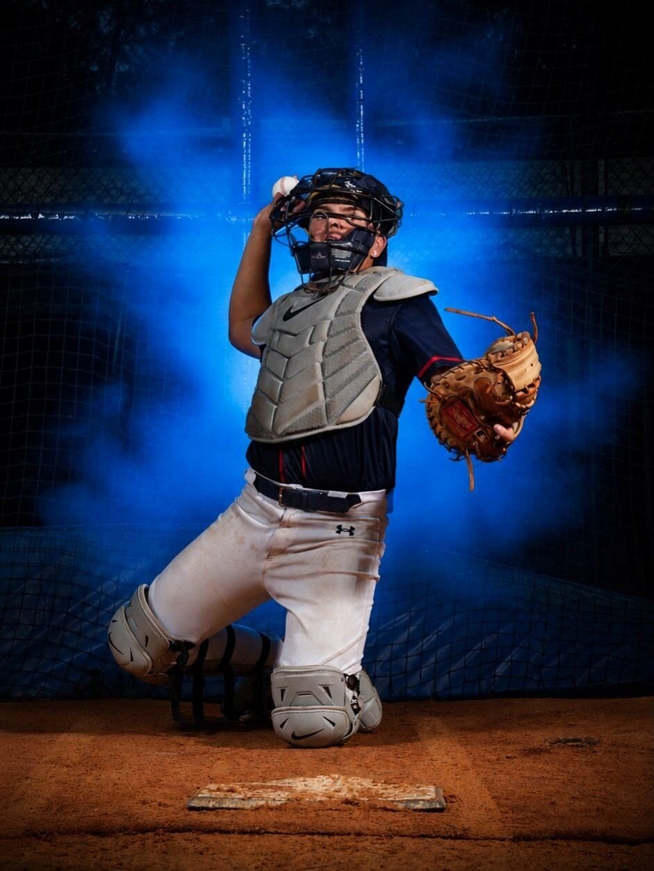 Catcher kneeling in a throwing pose with mask and glove