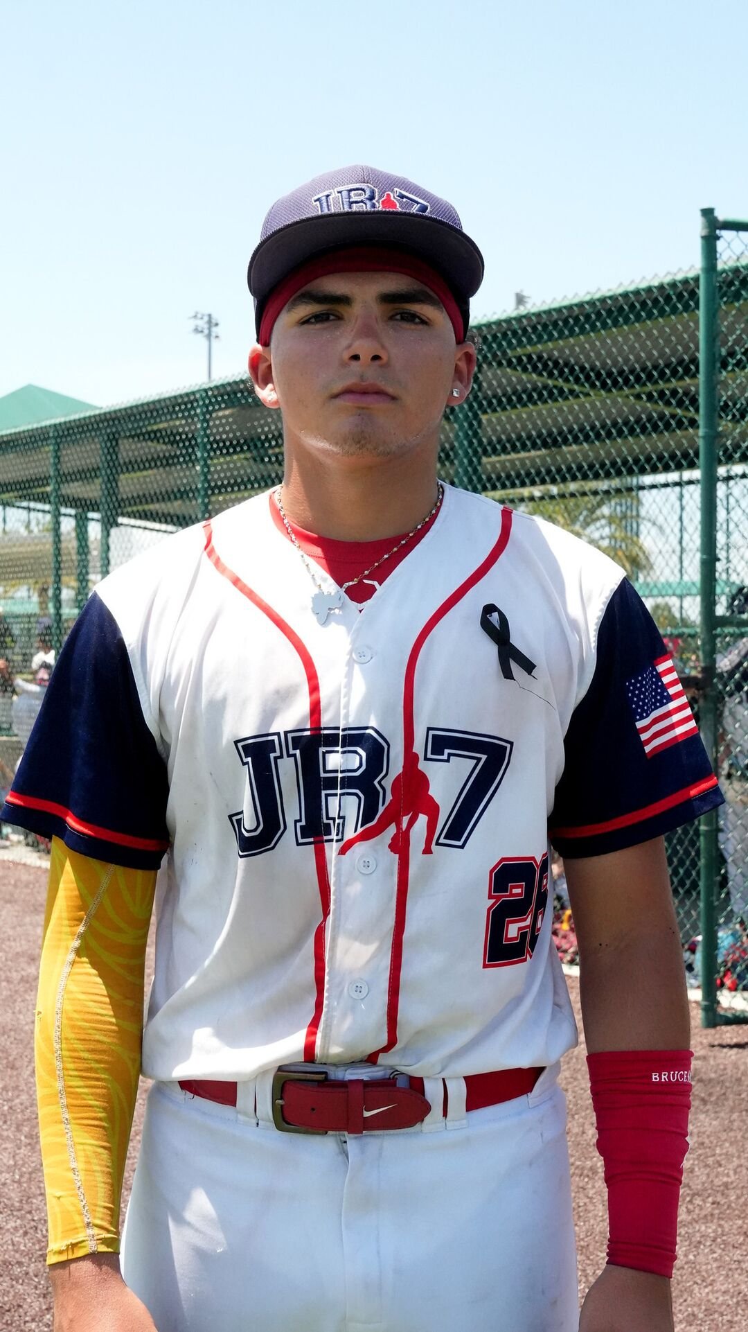 Portrait of a player in a white uniform with yellow sleeves