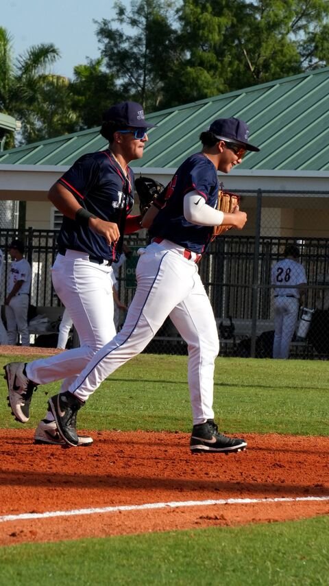 Two players warming up by the field