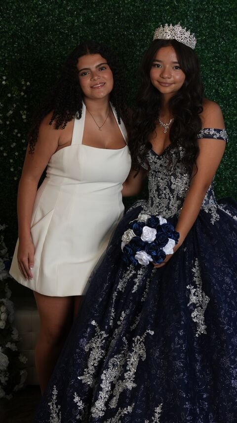 The quinceañera with a guest in a white dress