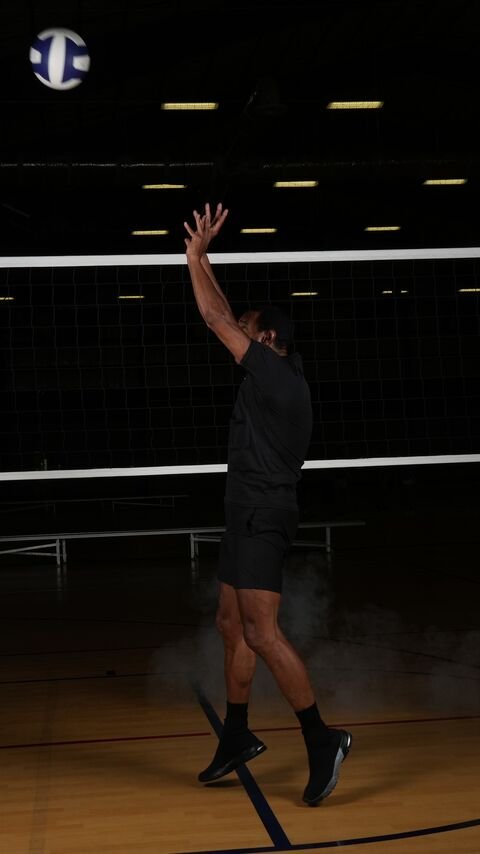 Player in the air with her arm raised