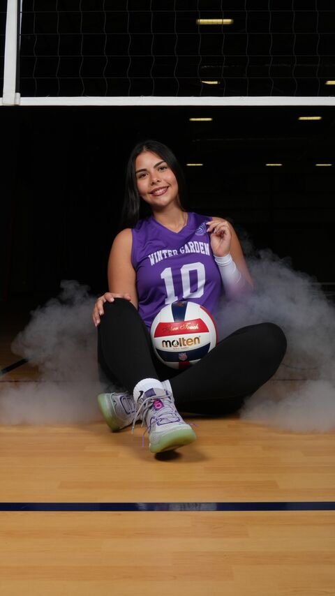 Player sitting on the court floor with the ball